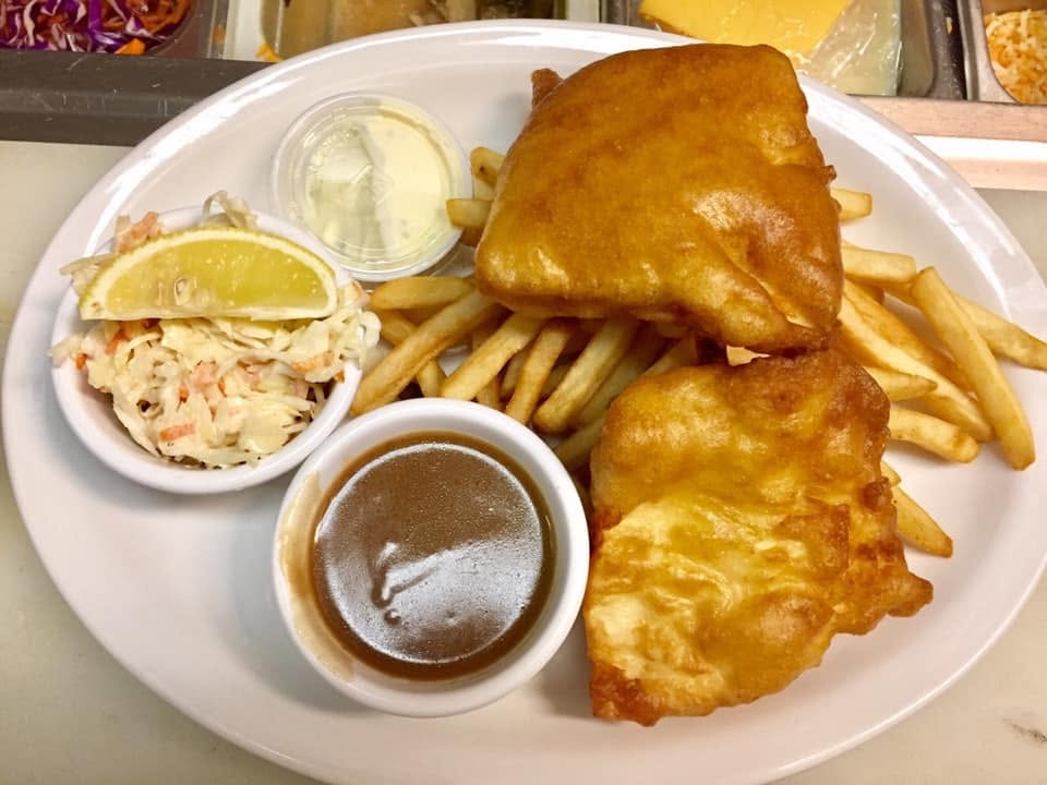 Halibut & chips — crispy golden battered fish with fries, coleslaw and tartar sauce