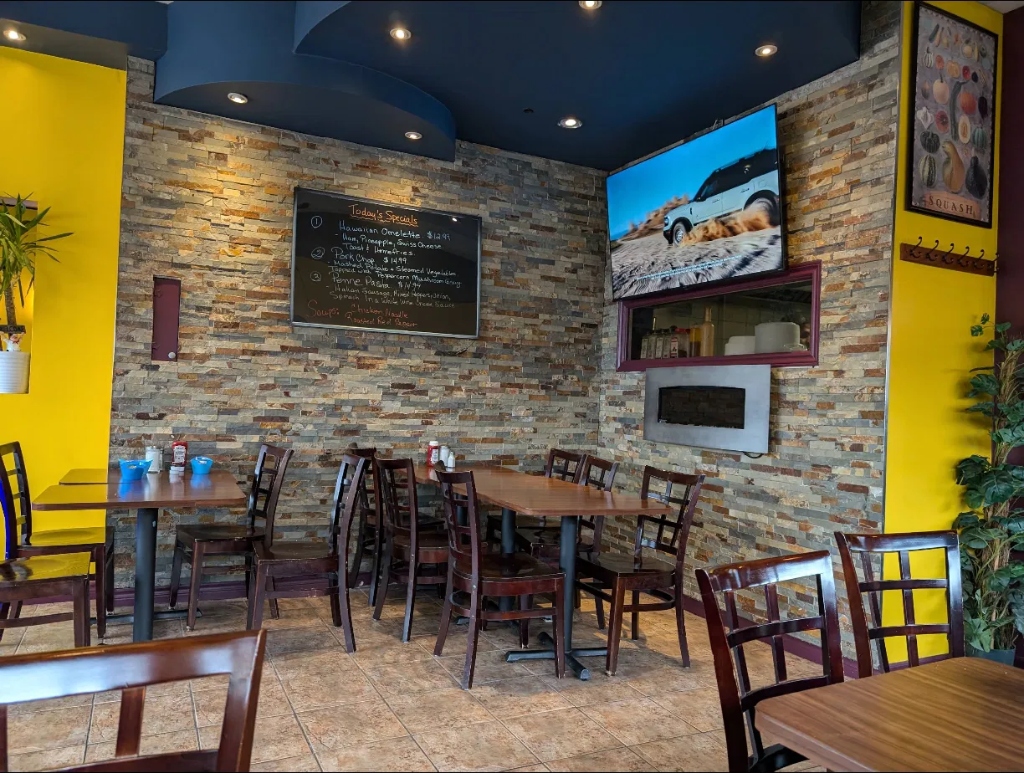 Stone fireplace accent wall with sports TV and daily specials board